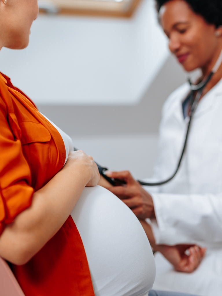 a doctor checking pregnant patient's vitals